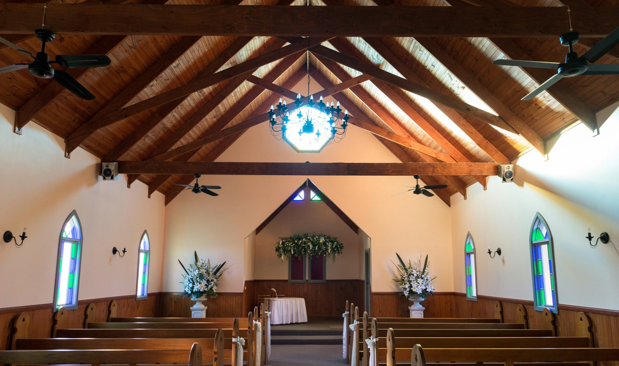 Inside the Lovedale Wedding Chapel, down the isle with pews either side.